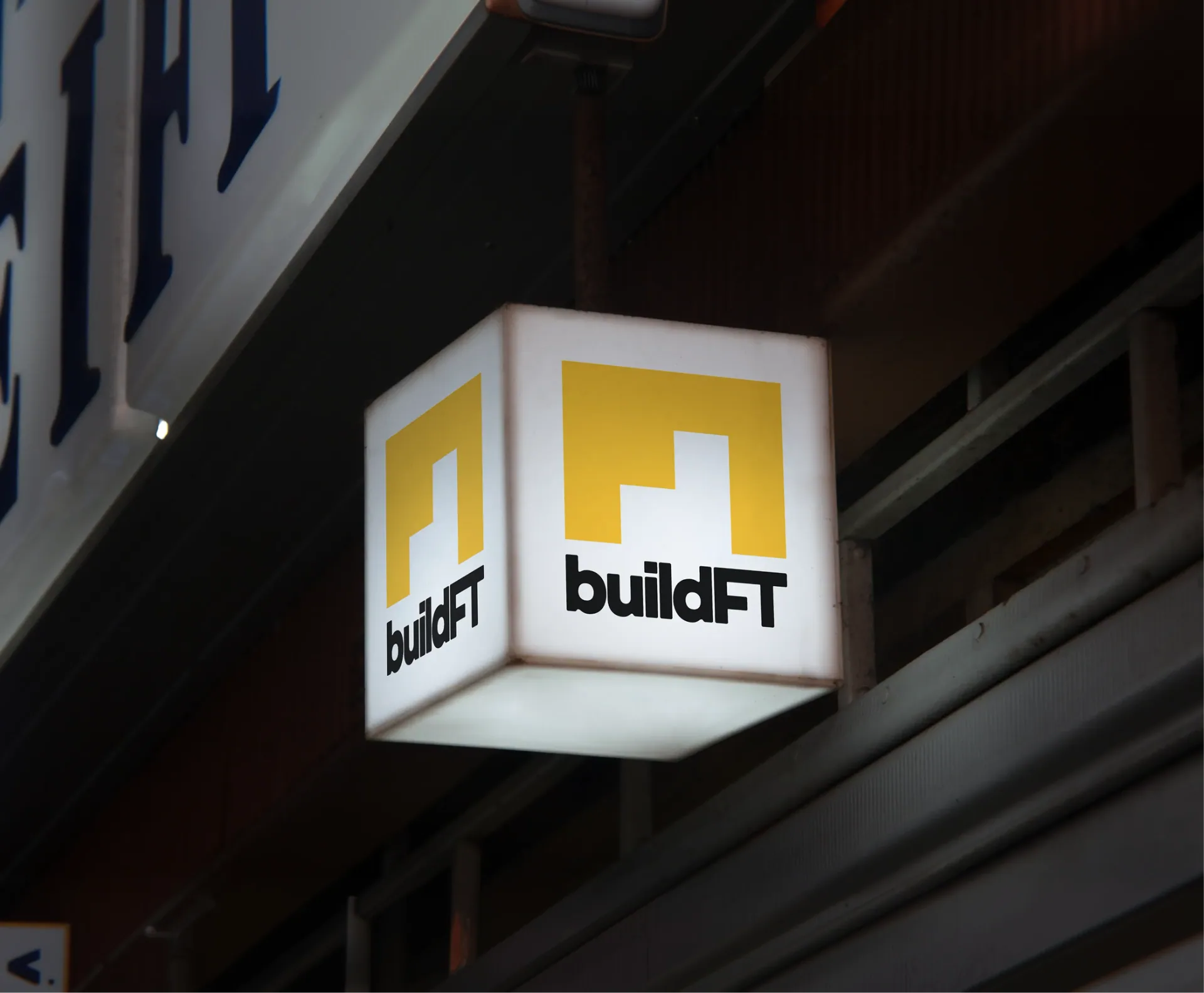 Illuminated BuildFT sign mounted on an exterior facade.