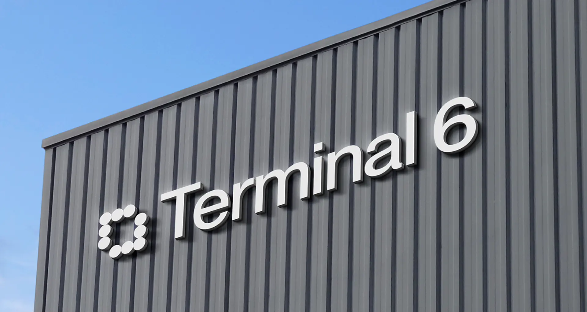 JFK Terminal 6 exterior signage with the dot-matrix logo mark.