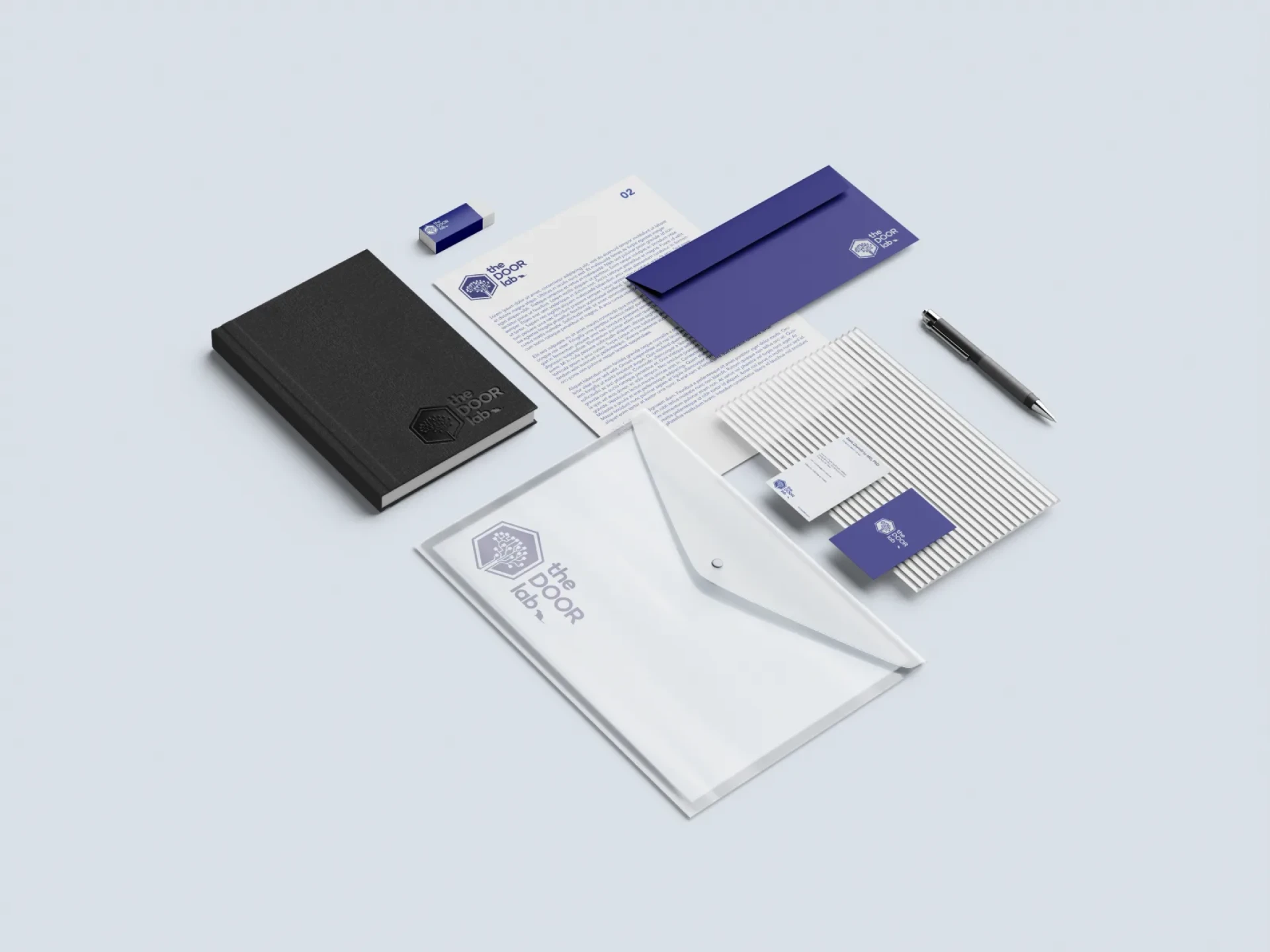 The DOOR Lab stationery system — notebook, letterhead, envelope, and business cards.