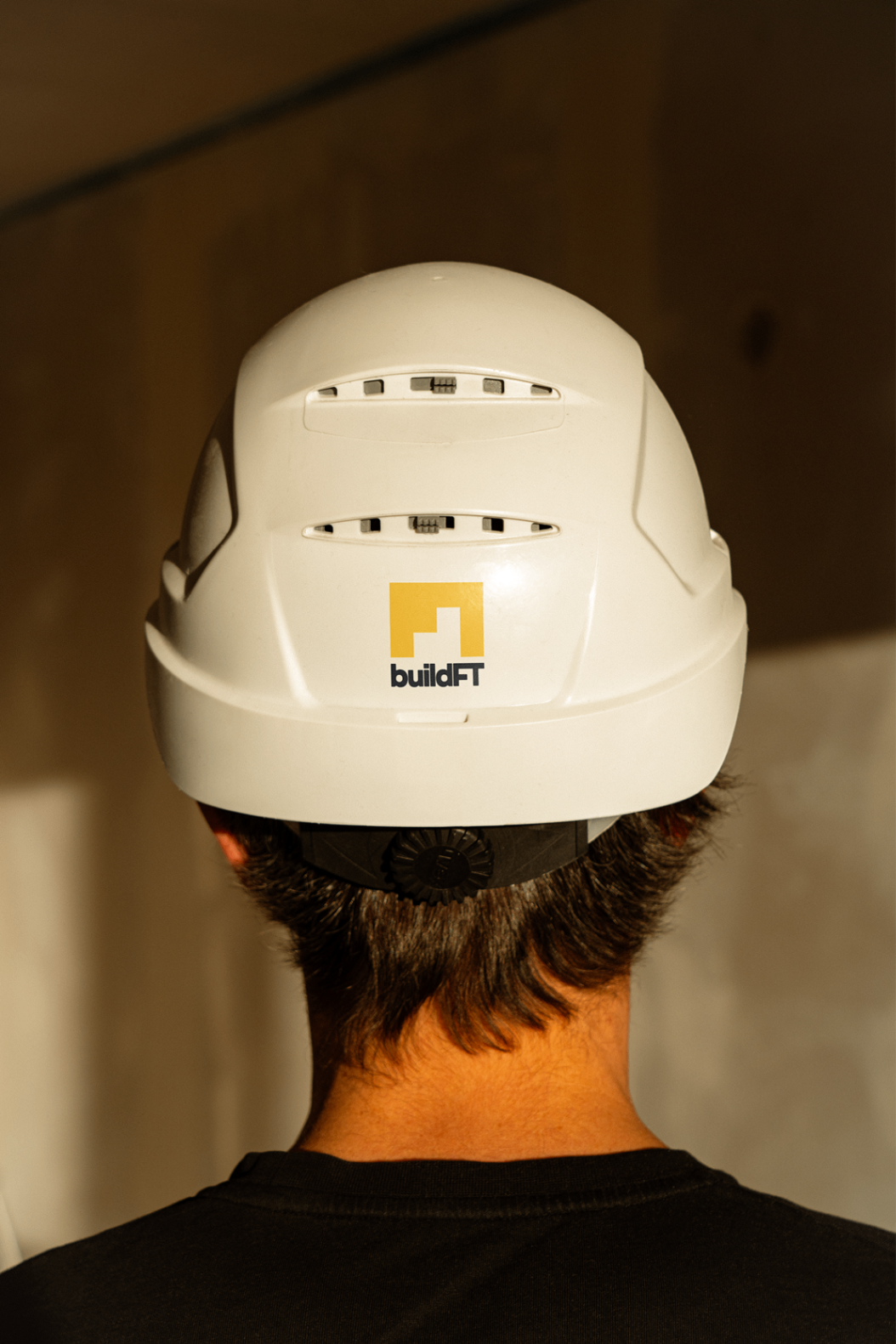 BuildFT logo applied to the back of a construction helmet.