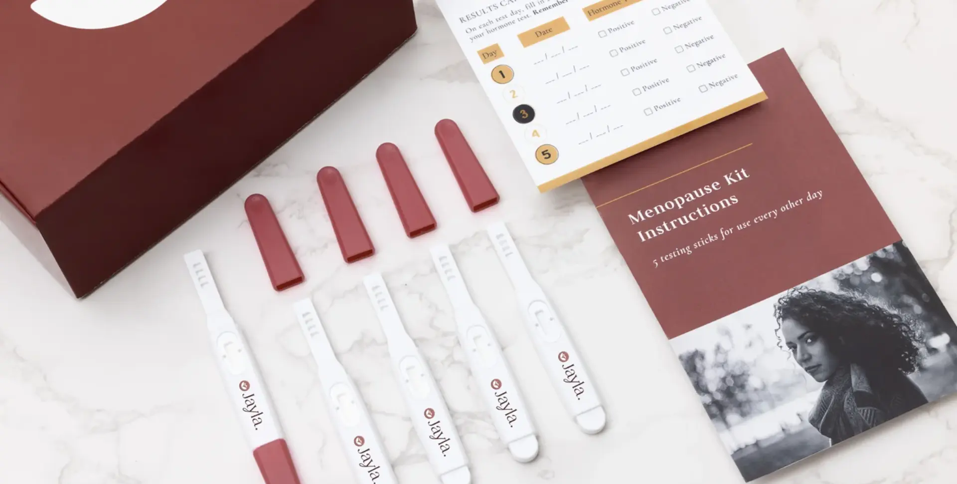 Jayla Health at-home hormone test kit with testing sticks, results card, and instruction booklet.