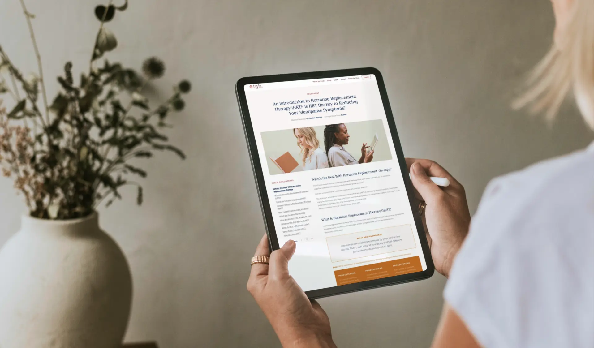 Jayla Health educational article on hormone replacement therapy on a tablet.