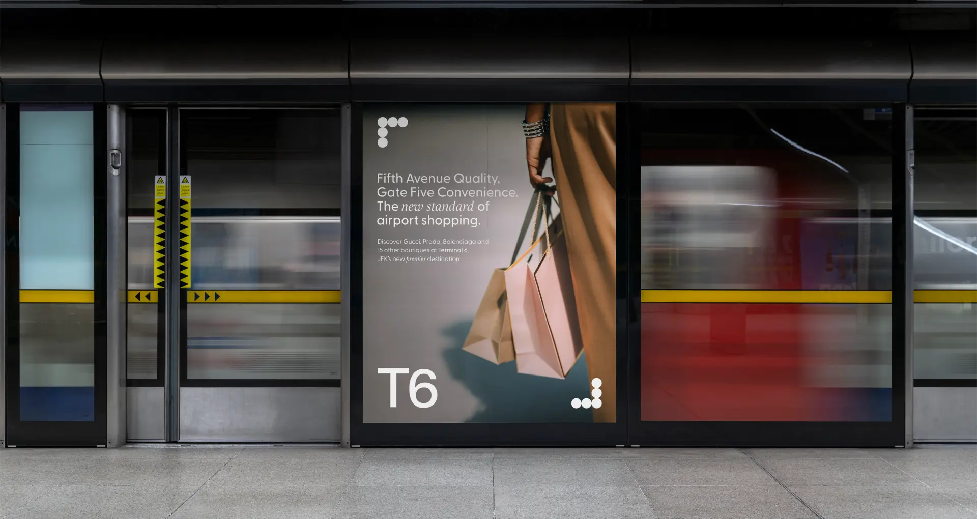 JFK Terminal 6 retail campaign poster on an airport train platform.
