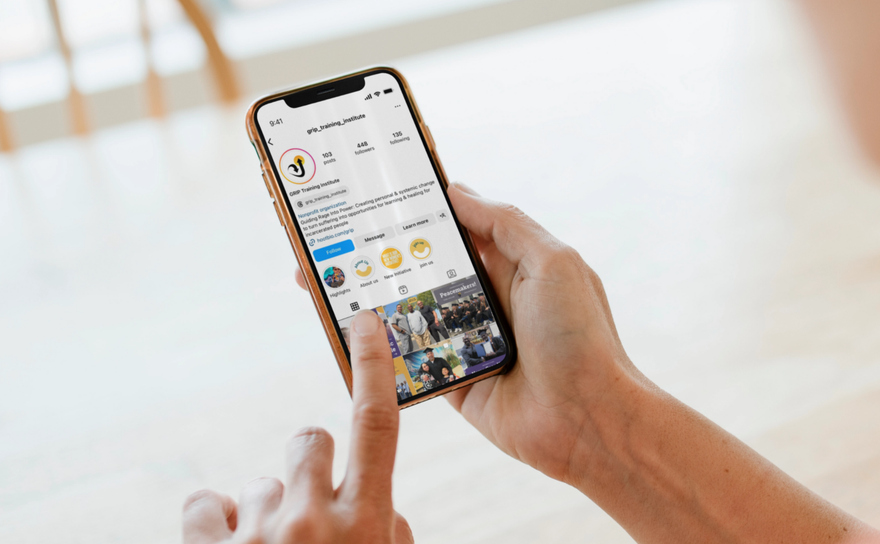 GRIP Training Institute Instagram profile viewed on a phone held in two hands.