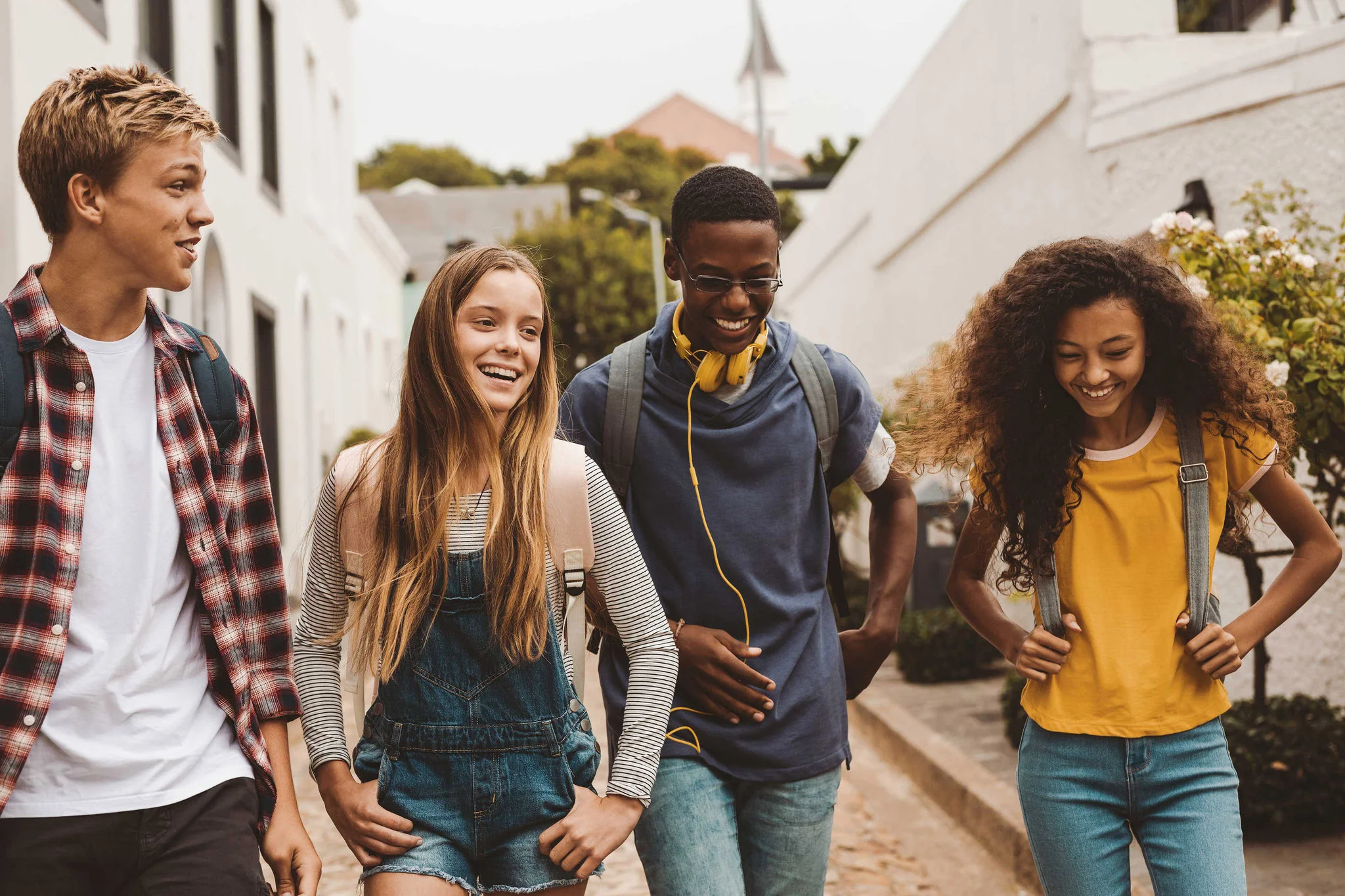 Diverse group of Gen Z students walking and laughing together on campus, representing key university marketing trends that emphasize authentic representation, inclusivity, and genuine student experiences in higher education outreach.